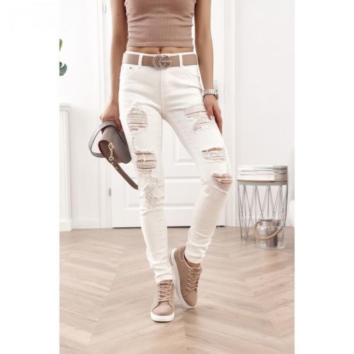 Fitted denim pants with holes in cream color