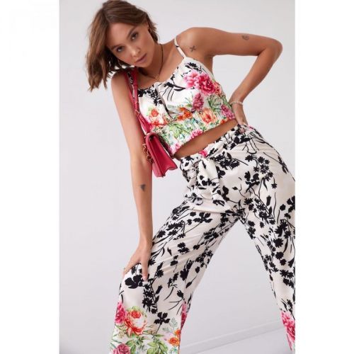 A satin set with floral wide trousers and a light beige black top