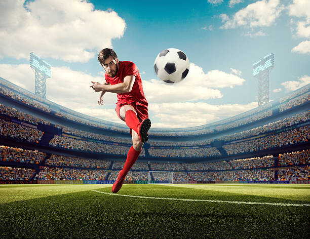 Dmytro Aksonov Umělecká fotografie Soccer player kicking ball in stadium, Dmytro Aksonov, (40 x 30 cm)