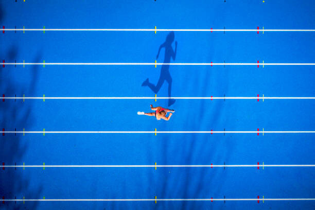 Westend61 Umělecká fotografie Top view of female runner on tartan track, Westend61, (40 x 26.7 cm)