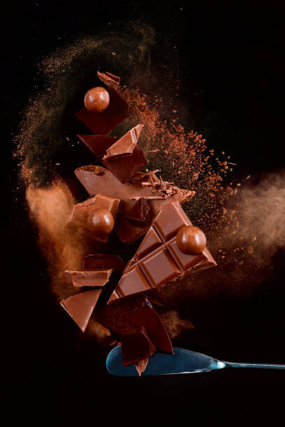 Dina Belenko Photography Umělecká fotografie Broken chocolate pieces balancing on a, Dina Belenko Photography, (26.7 x 40 cm)