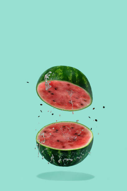 Amax Photo Umělecká fotografie Watermelon sliced flying on pastel green, Amax Photo, (26.7 x 40 cm)
