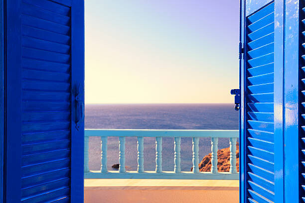 Ekspansio Umělecká fotografie Blue Shutters Open onto Sea and Sky at Dawn, Ekspansio, (40 x 26.7 cm)