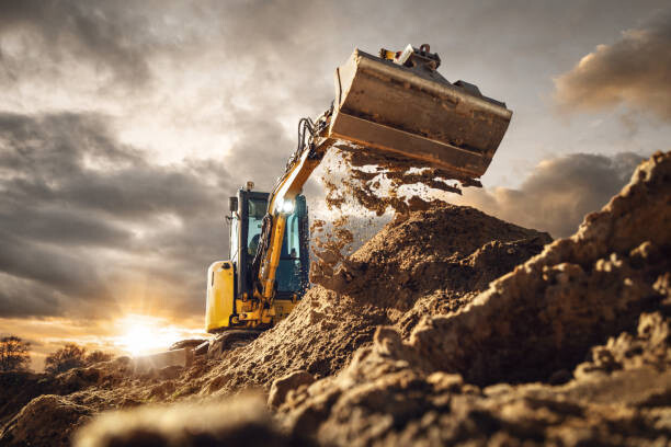 photoschmidt Ilustrace Excavator scooping dirt in front of a dramatic sky, photoschmidt, 40 × 26.7 cm