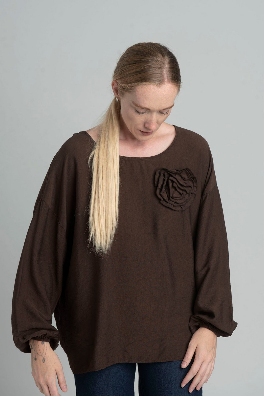 Oversized chocolate blouse with a decorative flower