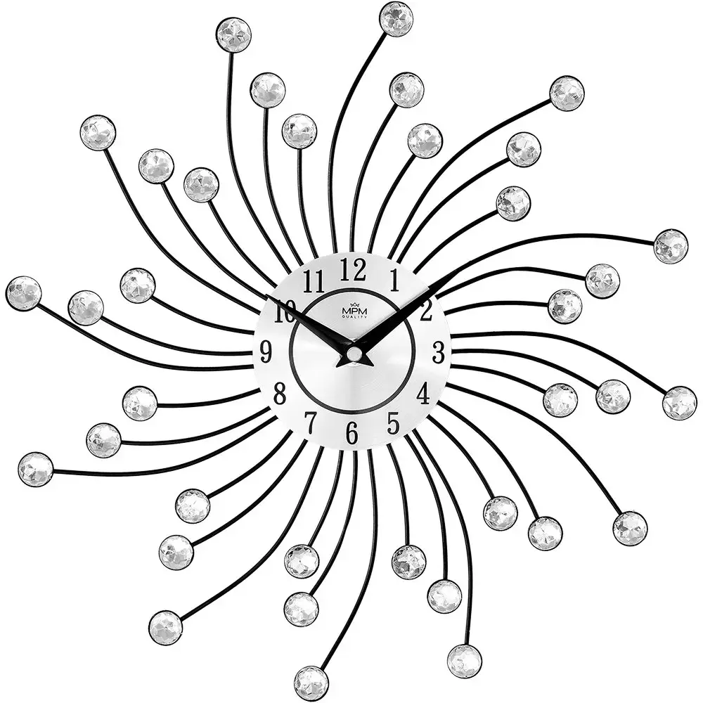 Kovové hodiny paprskovitého tvaru ozdobeného broušenými kamínky. Díky hodinovému strojku s plynulým chodem neruší hodiny nepříjemným tikáním E04.4495 MPM Sophia