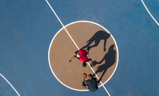 Hello Africa Plakát, Obraz - Aerial shot of 2 basketball players and shadows, Hello Africa, 40 × 24.1 cm