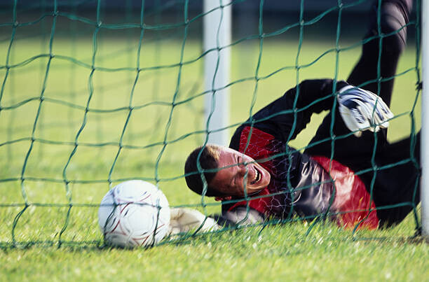 Photo and Co Plakát, Obraz - Male football goalie lying on field,, Photo and Co, 40 × 26.7 cm