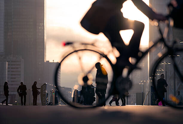 EschCollection Plakát, Obraz - Businessman on bicycle passing skyline La Defense, EschCollection, 40 × 26.7 cm