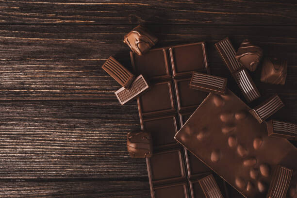 Olena Ruban Plakát, Obraz - Chocolate bars with nuts and candies close-up., Olena Ruban, 40 × 26.7 cm