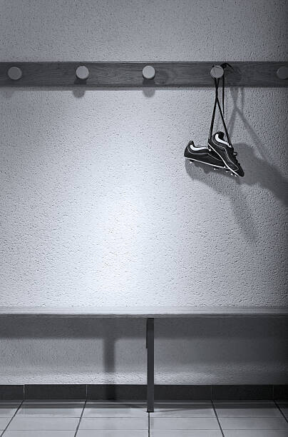 Photo and Co Plakát, Obraz - Football boots hanging in change room (B&W), Photo and Co, 26.7 × 40 cm