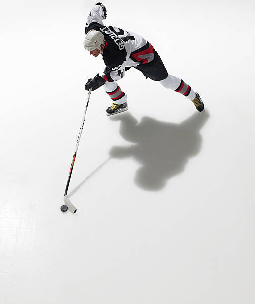 Ryan McVay Plakát, Obraz - Ice hockey player in possession of puck, Ryan McVay, 33.6 × 40 cm