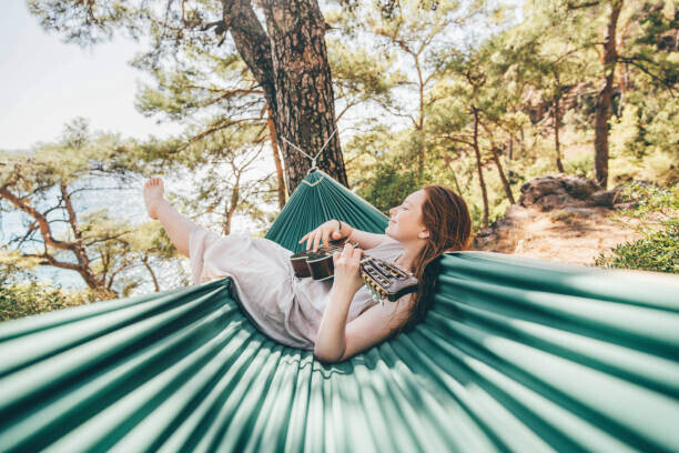 Maria Korneeva Plakát, Obraz - Woman relaxing in hammock and playing, Maria Korneeva, 40 × 26.7 cm