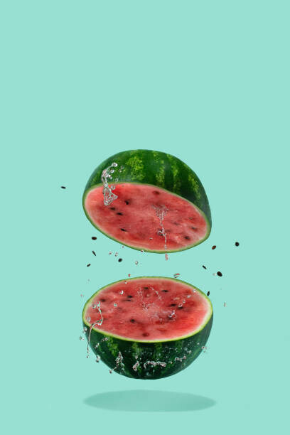 Amax Photo Plakát, Obraz - Watermelon sliced flying on pastel green, Amax Photo, 26.7 × 40 cm