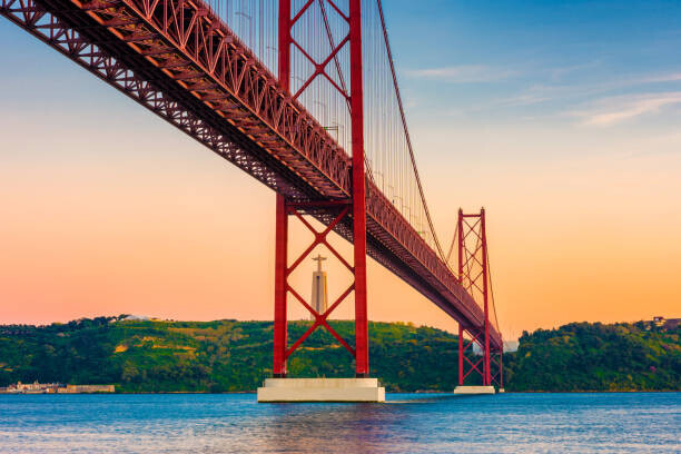 © Allard Schager Plakát, Obraz - 25th of April Bridge Lisbon Portugal at Sunset, © Allard Schager, 40 × 26.7 cm