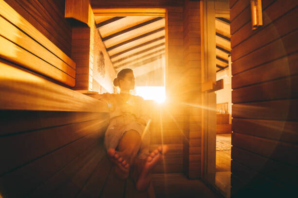 Yana Iskayeva Plakát, Obraz - A young woman relaxing in an eco wooden sauna, Yana Iskayeva, 40 × 26.7 cm