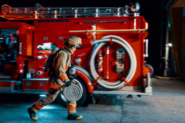 Trevor Williams Plakát, Obraz - Firefighter running with a hose next, Trevor Williams, 40 × 26.7 cm
