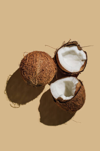 Tanja Ivanova Plakát, Obraz - Ripe coconuts on beige background. Creative, Tanja Ivanova, 26.7 × 40 cm