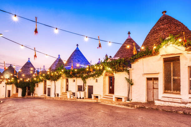 roman_slavik Plakát, Obraz - Famous Trulli Houses in Alberobello Illuminated, roman_slavik, 40 × 26.7 cm