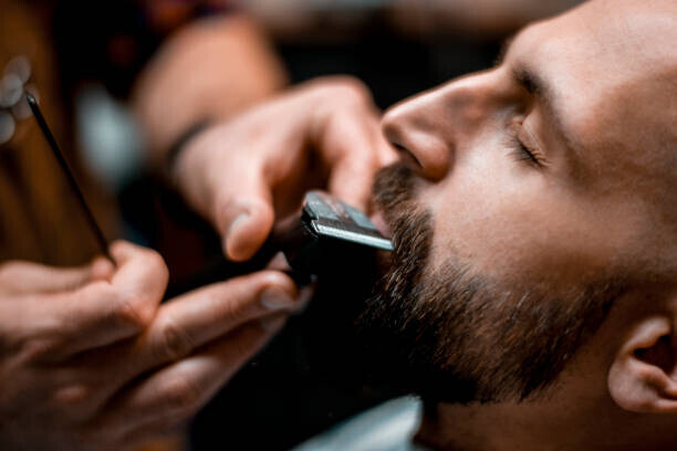 EXTREME-PHOTOGRAPHER Plakát, Obraz - Man getting his mustache shaped by, EXTREME-PHOTOGRAPHER, 40 × 26.7 cm