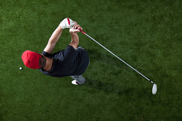 fStop Images - Halfdark Plakát, Obraz - A golfer swinging a golf club, overhead view, fStop Images - Halfdark, 40 × 26.7 cm