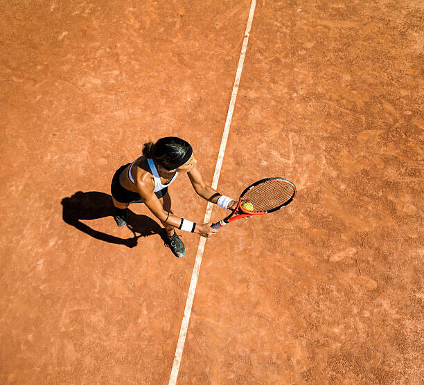 Nisian Hughes Plakát, Obraz - Woman tennis player about to hit a serve, Nisian Hughes, 40 × 40 cm